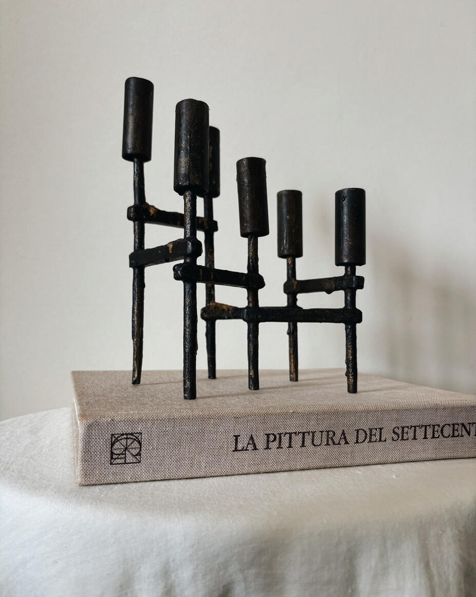 Black sculptural metal candle holder with six arms