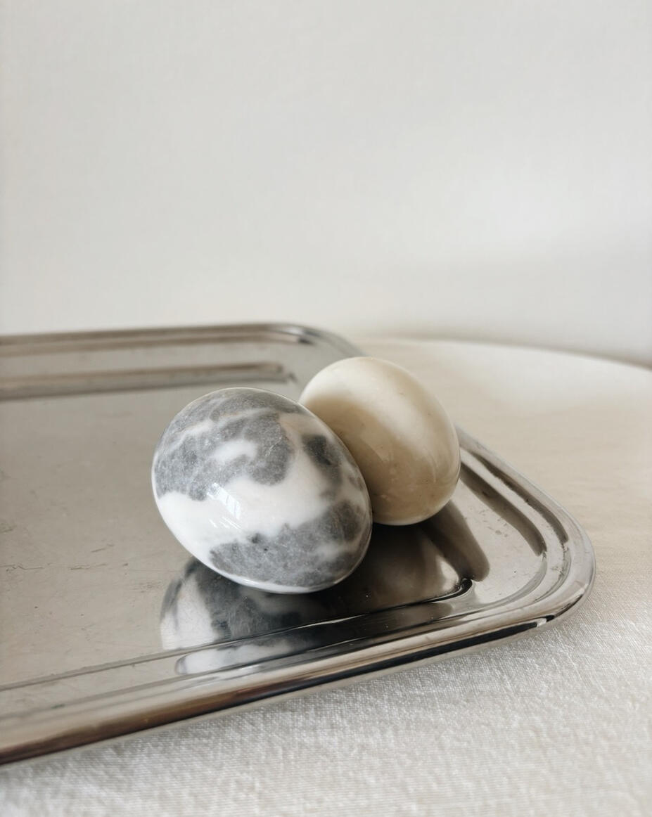 Marble decorative eggs on silver tray